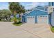 Charming blue condo with a two-car garage and lush tropical landscaping at 2023 Golfview Dr # 2023, Tarpon Springs, FL 34689