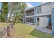 Well-maintained lawns and mature trees complement the exterior view of the blue condo building at 2023 Golfview Dr # 2023, Tarpon Springs, FL 34689