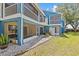 View of screened lanais, balconies, and lovely landscaping enhance the blue exterior at 2023 Golfview Dr # 2023, Tarpon Springs, FL 34689