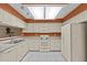 Clean kitchen featuring white appliances, cabinetry, and tile flooring at 2023 Golfview Dr # 2023, Tarpon Springs, FL 34689