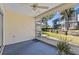 Enjoy the beautiful views from this screened lanai with a ceiling fan and blue outdoor carpet at 2023 Golfview Dr # 2023, Tarpon Springs, FL 34689
