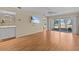 Open living area with TV, sliding glass doors to patio, and neutral walls at 2023 Golfview Dr # 2023, Tarpon Springs, FL 34689