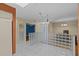 Bright space with tile and wood flooring, glass block, and view to additional room at 2023 Golfview Dr # 2023, Tarpon Springs, FL 34689