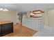 Open-concept space with wood flooring, glass block, and white kitchen in the background at 2023 Golfview Dr # 2023, Tarpon Springs, FL 34689