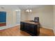Large office area with dark wood desk and laminate flooring at 2023 Golfview Dr # 2023, Tarpon Springs, FL 34689
