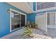 Private patio with plants, white fence, and a view of the blue exterior of the house at 2023 Golfview Dr # 2023, Tarpon Springs, FL 34689