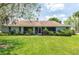 Spacious backyard with lush green grass, screened in patio, and beautiful landscaping at 206 147Th E St, Bradenton, FL 34212