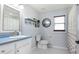 Well-lit bathroom with a blue countertop, bright mirror, and modern fixtures at 206 147Th E St, Bradenton, FL 34212