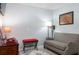 A comfy bedroom with a love seat, lamp, decorative rug, and a vintage telephone on a wooden desk at 206 147Th E St, Bradenton, FL 34212