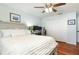 Comfortable bedroom featuring hardwood floors, a ceiling fan, and a spacious closet at 206 147Th E St, Bradenton, FL 34212