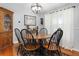 Charming dining room with a round table, black chairs, and elegant lighting at 206 147Th E St, Bradenton, FL 34212