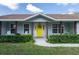 Inviting front entrance featuring a bright yellow door, well-kept lawn, and established landscaping at 206 147Th E St, Bradenton, FL 34212