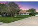 Charming single-story home with well-manicured lawn, mature trees, long driveway, and inviting curb appeal at 206 147Th E St, Bradenton, FL 34212