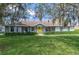 Charming home exterior with a yellow front door, well-maintained lawn, and established landscaping at 206 147Th E St, Bradenton, FL 34212