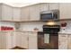 Well-lit kitchen with light wood cabinets, granite countertops, and stainless steel appliances at 206 147Th E St, Bradenton, FL 34212