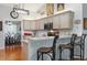 Well-lit kitchen featuring counter seating, stainless steel microwave, wooden cabinets and hardwood floors at 206 147Th E St, Bradenton, FL 34212