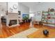 Open living room showcasing hardwood floors, a brick fireplace, and comfortable furnishings at 206 147Th E St, Bradenton, FL 34212