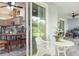 Outdoor patio with a dining table and chairs, connected to the kitchen, and ceiling fan overhead at 206 147Th E St, Bradenton, FL 34212