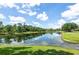 Scenic view of the community pond, reflecting the blue sky and surrounding trees at 206 147Th E St, Bradenton, FL 34212