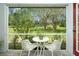 Relaxing screened porch with outdoor seating overlooking a tranquil backyard with pond view at 206 147Th E St, Bradenton, FL 34212