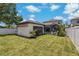A spacious backyard featuring a separate structure with landscaping offers privacy at 2109 N Jamaica St, Tampa, FL 33607