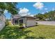 A spacious backyard with a detached structure and manicured landscaping creates privacy at 2109 N Jamaica St, Tampa, FL 33607