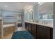 A bathroom featuring a double vanity with neutral counters, soaking tub, and calming blue walls at 2109 N Jamaica St, Tampa, FL 33607