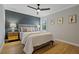 This bedroom offers a ceiling fan, picture windows, and stylish decor at 2109 N Jamaica St, Tampa, FL 33607