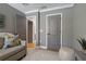 Cozy bedroom featuring plush seating, multiple doors, and a comfortable, inviting ambiance at 2109 N Jamaica St, Tampa, FL 33607