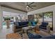 Inviting covered patio featuring comfortable seating, a ceiling fan, and views of the outdoor pool area at 2109 N Jamaica St, Tampa, FL 33607