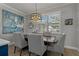 Dining area with modern light fixture, plantation shutters, wood floors, and stylish decor at 2109 N Jamaica St, Tampa, FL 33607