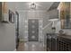 Welcoming foyer with hardwood floors, elegant lighting, and a stylish front door with glass accents at 2109 N Jamaica St, Tampa, FL 33607