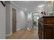 Open hallway with wood floors leading to bedrooms and bathrooms with neutral decor at 2109 N Jamaica St, Tampa, FL 33607