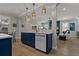 View of kitchen with quartz counters, blue cabinets, and breakfast bar with pendant lighting at 2109 N Jamaica St, Tampa, FL 33607