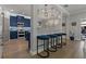 Stylish kitchen featuring blue cabinets, modern appliances, a breakfast bar with seating, and pendant lighting at 2109 N Jamaica St, Tampa, FL 33607