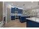 Beautiful kitchen features custom blue cabinets, modern stainless appliances and an island at 2109 N Jamaica St, Tampa, FL 33607