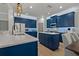 Bright kitchen boasts stylish blue cabinets, quartz countertops, and stainless steel appliances at 2109 N Jamaica St, Tampa, FL 33607
