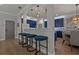 Open-concept kitchen featuring breakfast bar, modern lighting, and elegant blue cabinets at 2109 N Jamaica St, Tampa, FL 33607