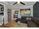 Stylish living room with hardwood floors, dark sectional sofa, and a ladder shelf at 2109 N Jamaica St, Tampa, FL 33607
