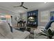Comfortable living room featuring a modern ceiling fan, a grand piano, and plenty of natural light at 2109 N Jamaica St, Tampa, FL 33607