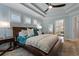Comfortable main bedroom with a tray ceiling, and a door leading into the main bathroom at 2109 N Jamaica St, Tampa, FL 33607