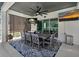 Covered outdoor dining area with a large table, seating for eight, and dual televisions at 2109 N Jamaica St, Tampa, FL 33607