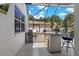 Outdoor kitchen featuring a built-in grill, countertop space, and screened patio at 2109 N Jamaica St, Tampa, FL 33607