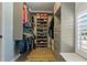 This walk in closet offers ample storage solutions with shelves, cabinets, and hanging rods at 2109 N Jamaica St, Tampa, FL 33607