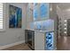 Stylish wet bar featuring wine storage, beverage cooler, and illuminated glass-front cabinets at 2109 N Jamaica St, Tampa, FL 33607