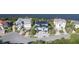 Aerial view of blue house on a waterfront street with mature landscaping at 2111 Alexis Ct, Tarpon Springs, FL 34689