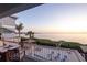 Relaxing balcony view with outdoor seating, overlooking the ocean, pool and entertainment area at 2111 Alexis Ct, Tarpon Springs, FL 34689