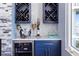 Stylish bar area with wine storage, marble countertop, and custom cabinetry, ideal for entertaining at 2111 Alexis Ct, Tarpon Springs, FL 34689