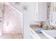 Bathroom featuring mosaic tile shower, white vanity, and granite countertop at 2111 Alexis Ct, Tarpon Springs, FL 34689
