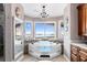 Luxury bathroom featuring a jacuzzi tub with stunning water views and a modern chandelier at 2111 Alexis Ct, Tarpon Springs, FL 34689